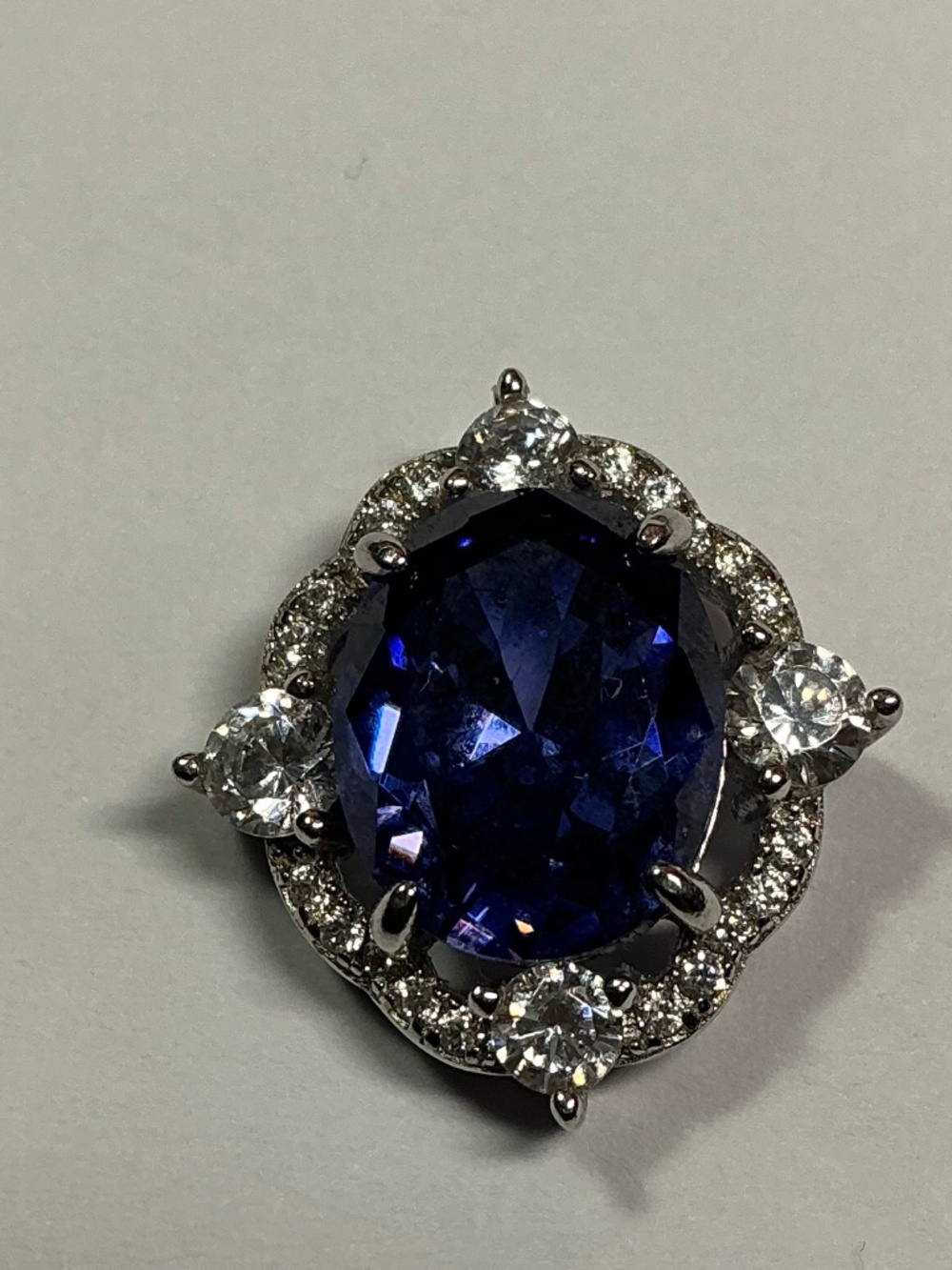 Sterling Signed Pendant with a Center Blue Stone Surrounded by clear stones.